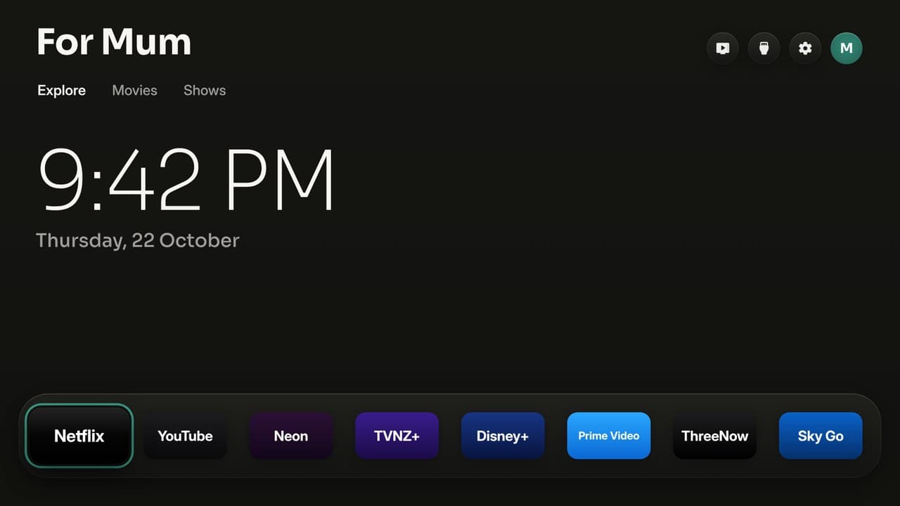 The home screen at night: a big clock and the streaming apps on one shelf